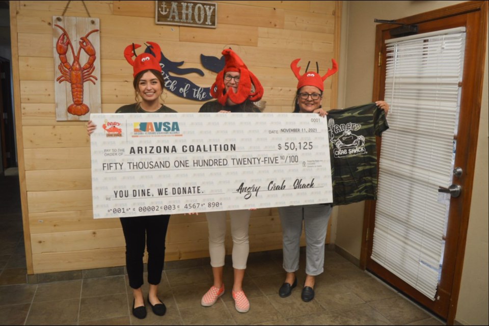 The 2021 donation handoff to the Arizona Housing Coalition. Angry Crab Shack raised $75,000 this year to benefit unhoused veterans.