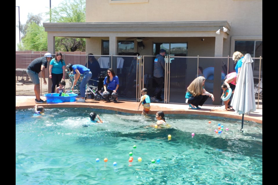 The Weatherly family with their new pool fence and new friends at Child Crisis Arizona, SRP and the 493 Firefighter Foundation.