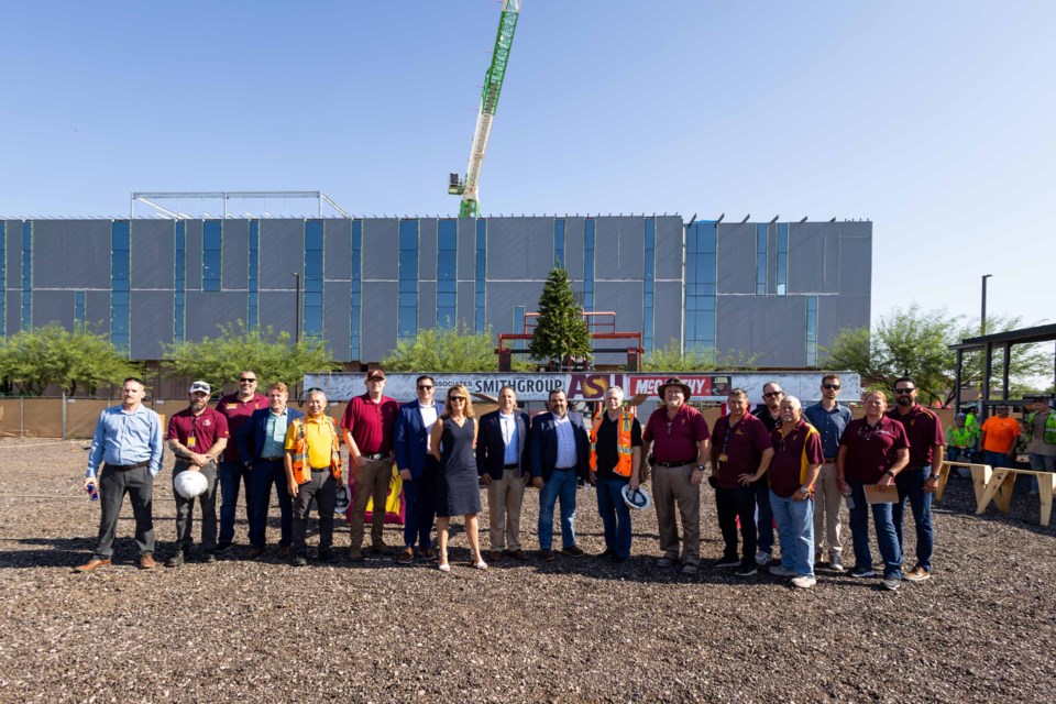 The $185 million Interdisciplinary Science and Technology Building 12 project at Arizona State University’s Polytechnic campus in southeast Mesa, near Queen Creek, recently reached the topping out construction milestone, marking the placement of the structure’s final beam.