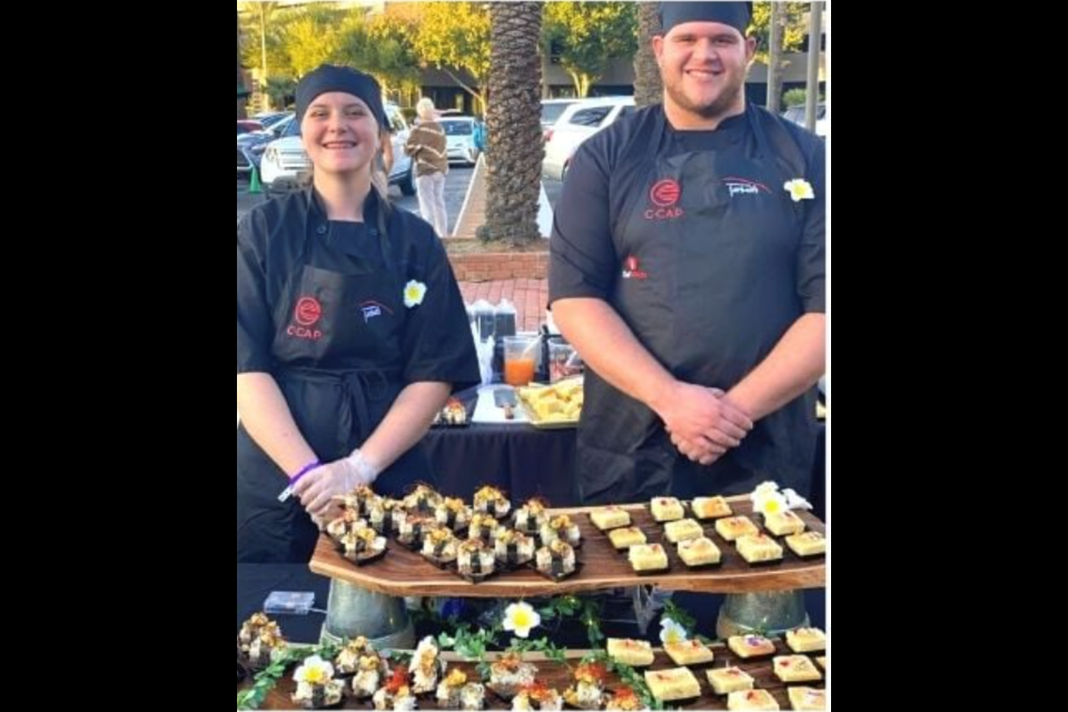 Queen Creek High culinary students Sara Bohart and Kevin Fackrell worked the Harvest Moon Feast with mentor Chef Elizabeth Meinz on Oct. 20, 2021.