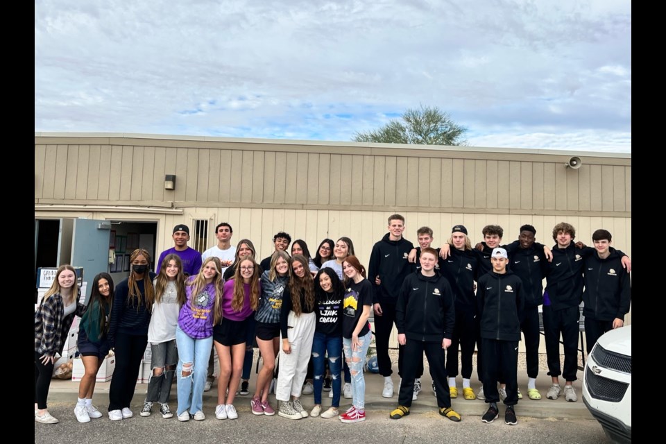 Queen Creek High School volunteers from the boys varsity basketball team, link crew and student council collected food and donations through its inaugural Winner, Winner Turkey Dinner Drive.