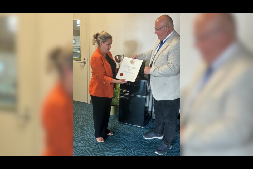 Teara Fraser, founder of Iskwew Air, (left) receiving the Master's North American Trophy Award from Master Richie Piper in Richmond.