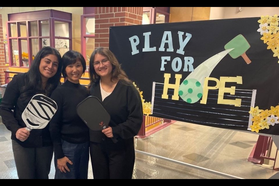 Maya Parmar (left) and Alexandra Mejia (right) are organizing a charity pickleball tournament with the help of teacher Linda Wong.