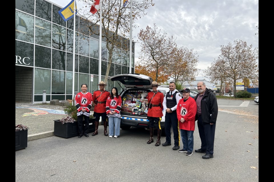 Members of the Richmond RCMP, Richmond Sockeyes and Richmond Cares, Richmond Gives CEO Ed Gavsie on Nov. 8 at the RCMP's main detachment.