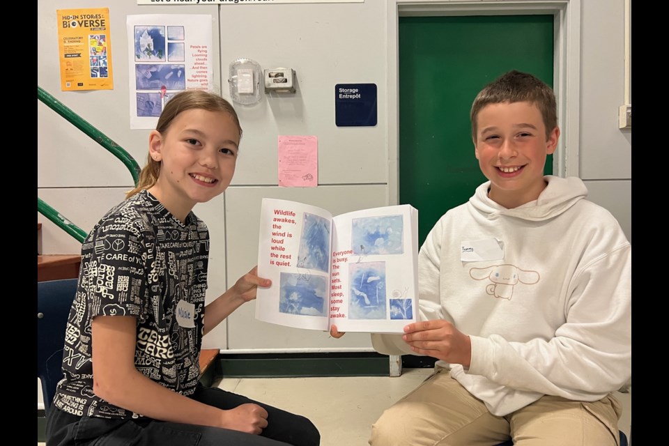 Dixon elementary's Maisie Peter and Tommy McKane showing off Tommy's page in the comic book.