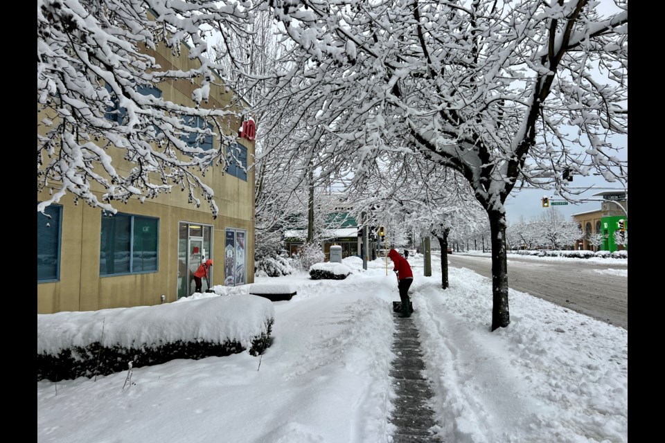 Community members shovelling the sidewalk in Richmond.