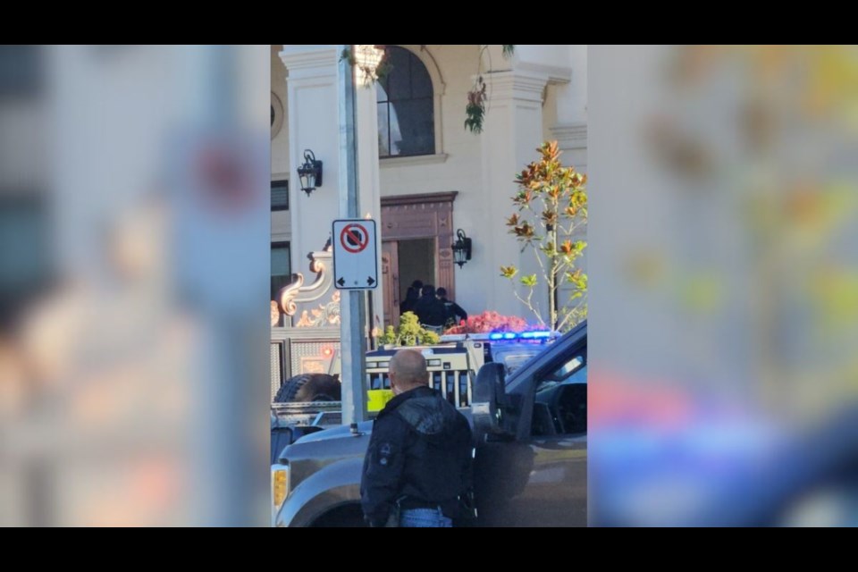 Law enforcement officers were seen entering a large home in Steveston.