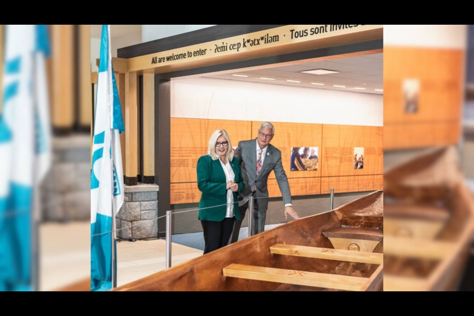 Former YVR CEO Craig Richmond (right) with current YVR CEO Tamara Vrooman at the canoe in The Gathering Place. 