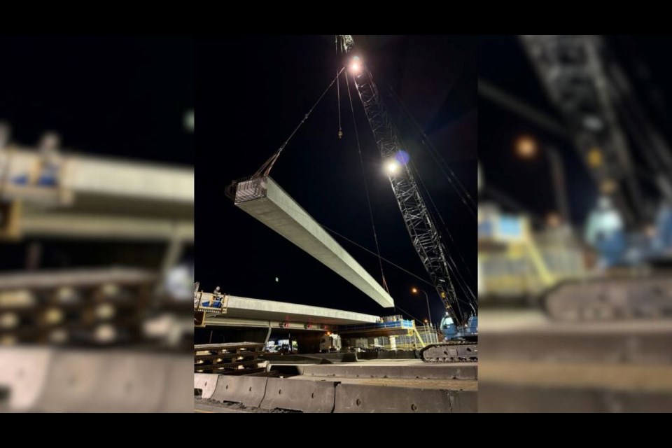 A heavy-lift crane hoisted a 35-metre, 50-tonne girder in June.