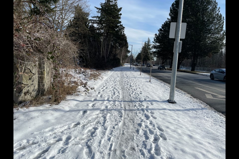 Snow-covered sidewalks on westbound side of Alderbridge Way at Fisher Drive.