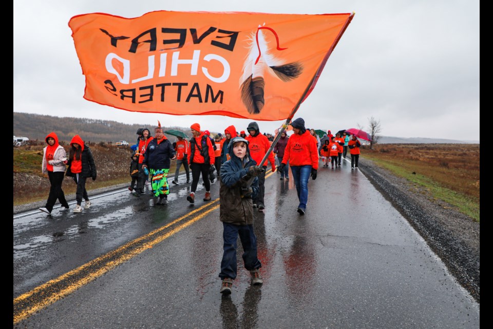 People march down Highway 1A from McDougall Memorial United Church – located in the MD of Bighorn boundary – to the Morley United Church in Mînî Thnî to mark the National Day for Truth and Reconciliation on Sept. 30, 2023. JUNGMIN HAM RMO PHOTO