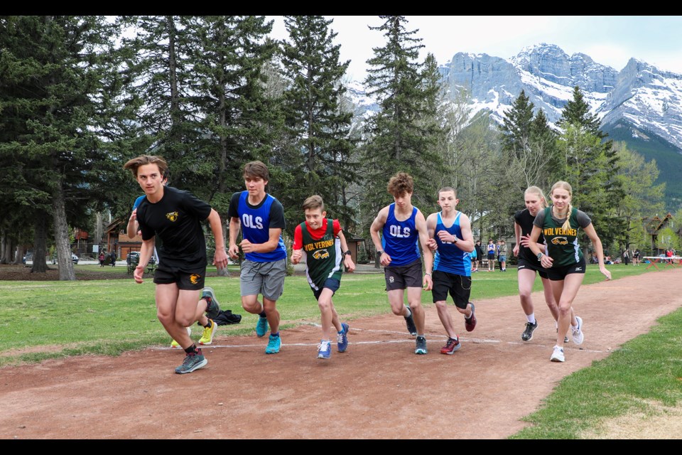 Students in the 3,000-metre and 1,500-metre race out of the start line during the senior high regional track meet at Centennial Park in Canmore on Wednesday (May 15). JUNGMIN HAM RMO PHOTO