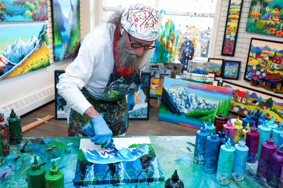 Montreal artist Surge Dubé creates artwork during a live demonstration event at Fallen Leaf Art Gallery in Canmore on Saturday (May 18). Dubé doesn't use a brush and prefers to dump an entire container of acrylic paint onto the canvas to get the brightest, strongest pigment possible. JUNGMIN HAM RMO PHOTO