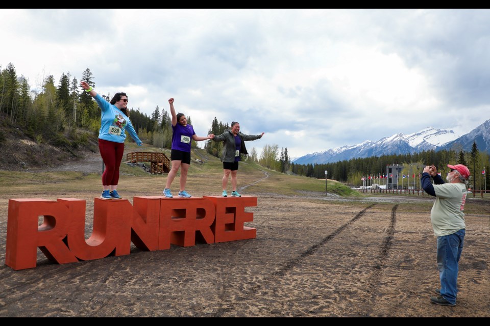 Volunteer Bruce Watson snaps a picture for the 'gram of Amelia Millward, Lucy Firlotte and Linda Dip at the annual Women's Soap Run at the Canmore Nordic Centre on Friday (May 24). JUNGMIN HAM RMO PHOTO