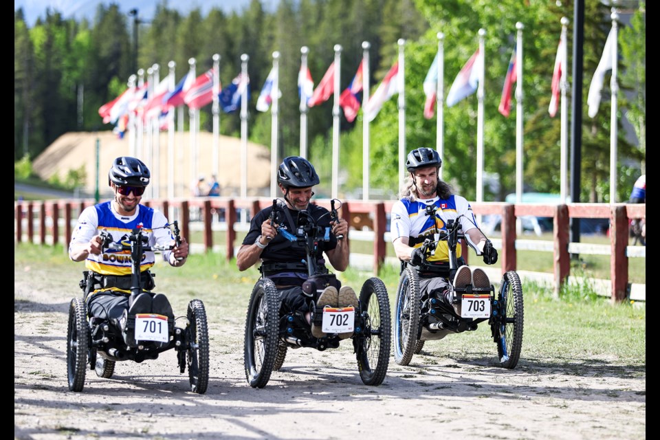 Gustavo Ortiz (No. 701), Christian Bagg (No. 702) and David Sagal (No. 703) speed off the starting line in Alberta's first-ever adaptive cross-country bike race at the 2024 Canmore Canada Cup XCC at the Canmore Nordic Centre on Thursday (June 13). JUNGMIN HAM RMO PHOTO 