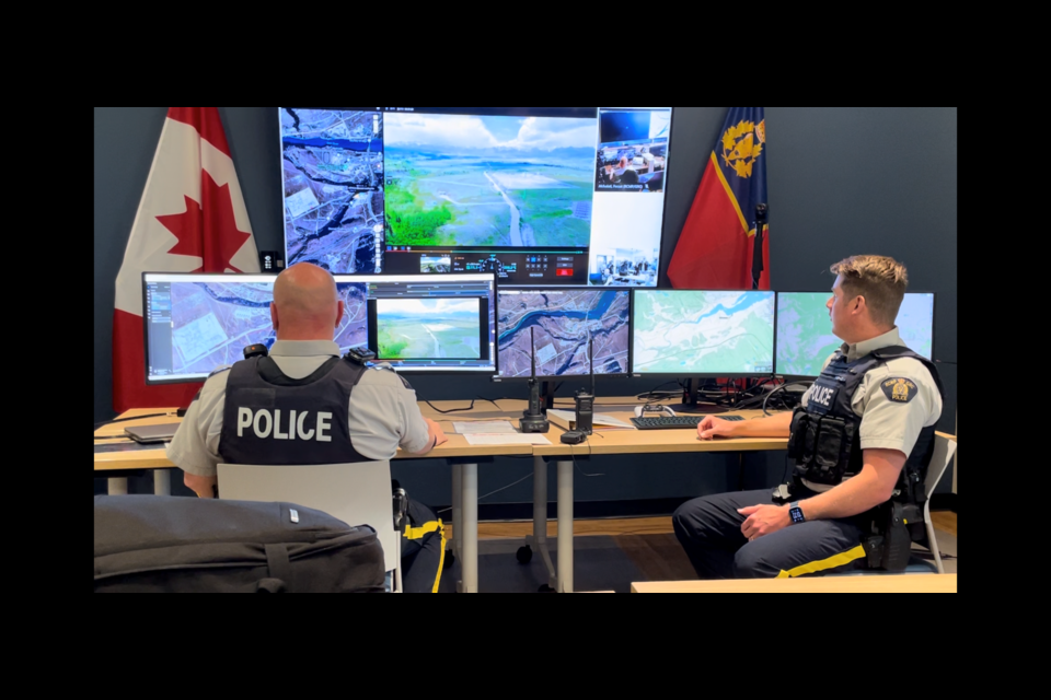 An image of Îyârhe (Stoney) Nakoda First Nation is mirrored onto a television screen at the Cochrane RCMP detachment as trained RCMP officers remotely pilot a drone over the First Nation in real-time on Friday (June 14). JESSICA LEE RMO PHOTO