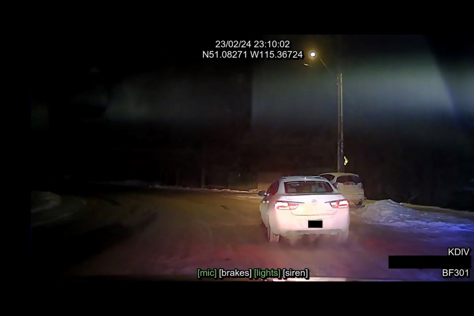 A photo from the police officer’s dash cam following the white Buick Verano on Feb. 24, 2023. ASIRT PHOTO