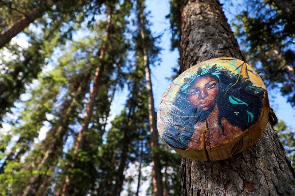 Artist Sydonne Warren's wood cookie painting "Pine Cone" is part of the Art in Nature Trail, located along the Bow River Trail in Banff on Thursday (July 4). Art in Nature Trail runs until Sept. 30. JUNGMIN HAM RMO PHOTO 