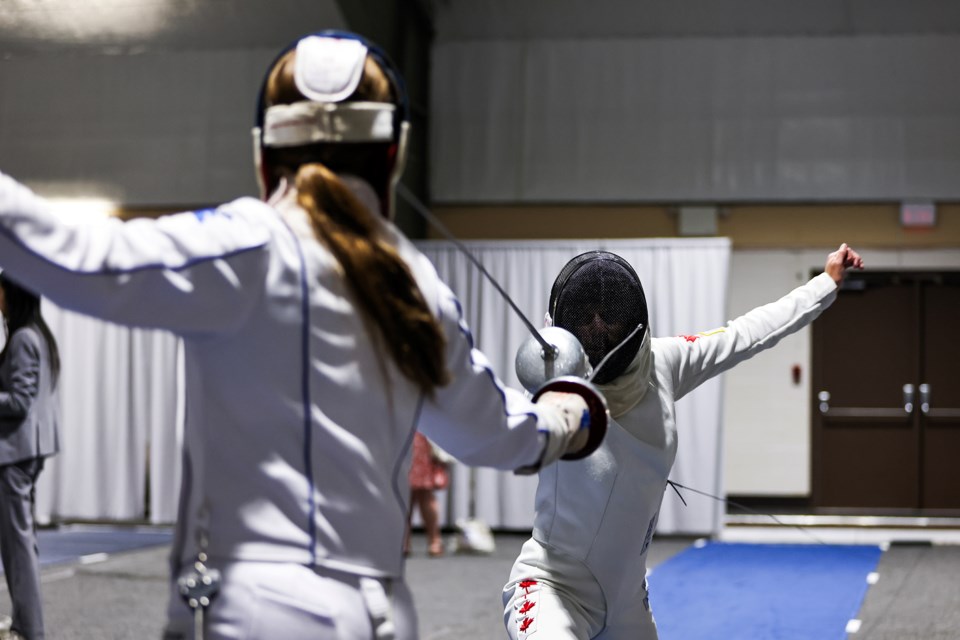 Elena Arkison, right, and Sara Johnston duel in fencing during the 2024 Modern Pentathlon National Championships in Canmore on Saturday (July 6).  JUNGMIN HAM RMO PHOTO