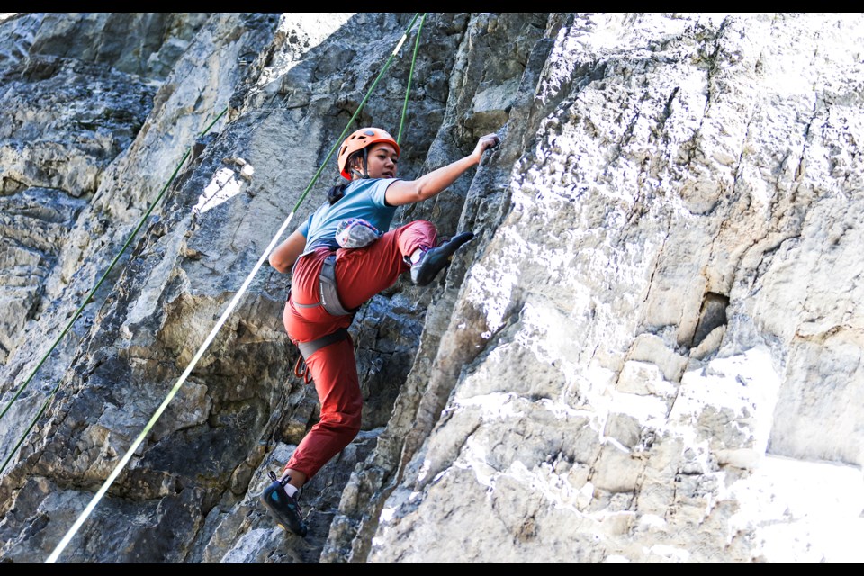 Sharon De Los Santos from Texas climbs a route on a rock face at Brewster Trail in Banff on Saturday (July 6). JUNGMIN HAM RMO PHOTO 