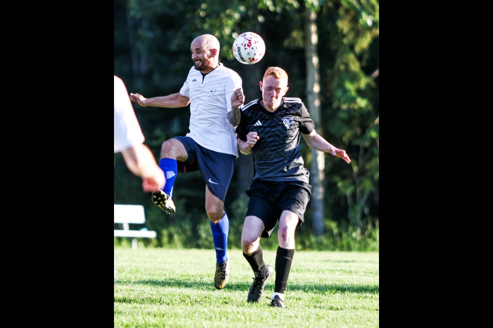 Canmore United's Lucas Planteline, left, and Banff Springs FC's Adam Lamas go for a header during a match in the Bow Valley Soccer League at Millennium Field in Canmore on Thursday (July 11). Canmore United won 2-1. JUNGMIN HAM RMO PHOTO