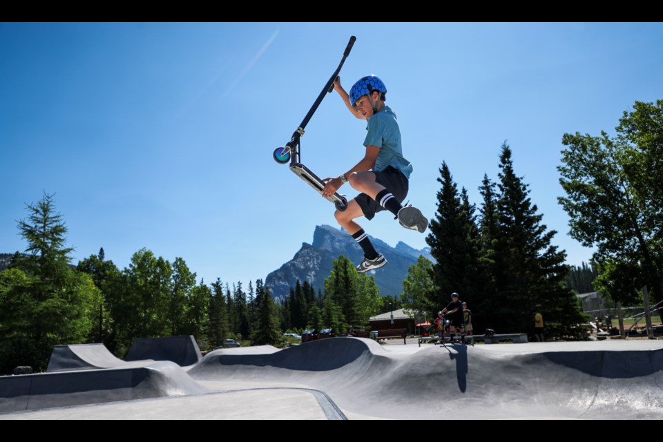 Jake Huerlimann performs the tail grab during the annual skatepark community barbecue hosted by BanffLIFE in Banff on Thursday (July 11). JUNGMIN HAM RMO PHOTO