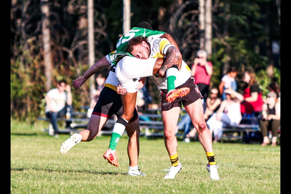 Banff Bears Will Timmins picks up a Calgary Irish player and knocks him over during a home game on Wednesday (July 17) at Banff Recreation Grounds. Banff won 32-21.  JUNGMIN HAM RMO PHOTO

