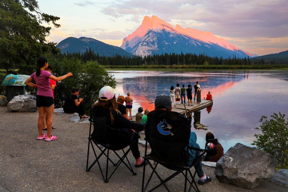 Visitors to Banff National Park relax along the shores and observe the sunset at Vermilion Lakes on Wednesday (July 17). JUNGMIN HAM RMO PHOTO