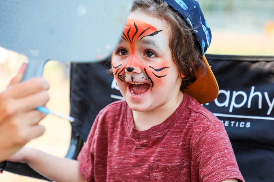 Hunter Bowlin is happy to see his face turned into a tiger after face-painting during the Rotary Club of Banff's Centennial Community Day at the pavilion building at the Banff Recreation Grounds on Saturday (July 20). JUNGMIN HAM RMO PHOTO

