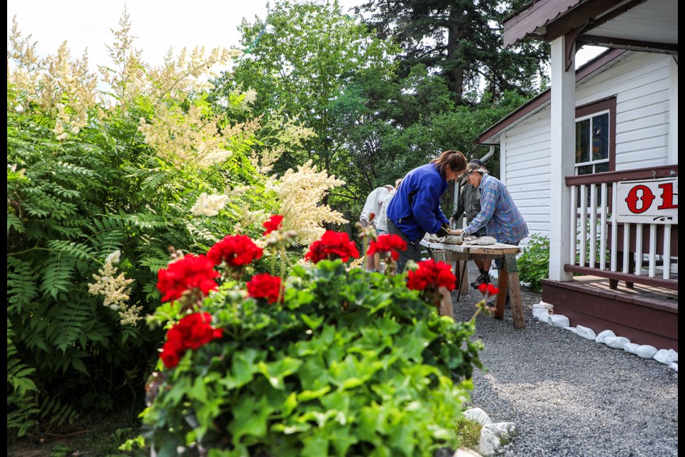 Volunteers clean up deteriorating heritage garden stones at the North West Mounted Police (NWMP) Barracks on Friday (July 26). JUNGMIN HAM RMO PHOTO