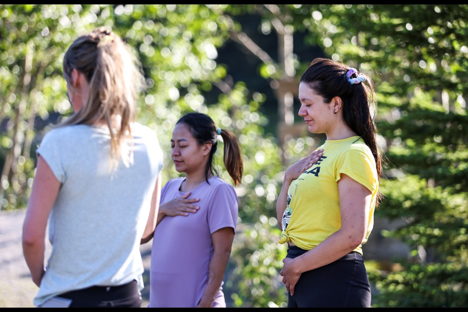 Numfon Pungaksorn, left, and Rafaela Stuardo take in breathing exercises during the Gathering Circle session held by YWCA Banff at Cascade Ponds in Banff National Park on Thursday (Aug.1). JUNGMIN HAM RMO PHOTO 