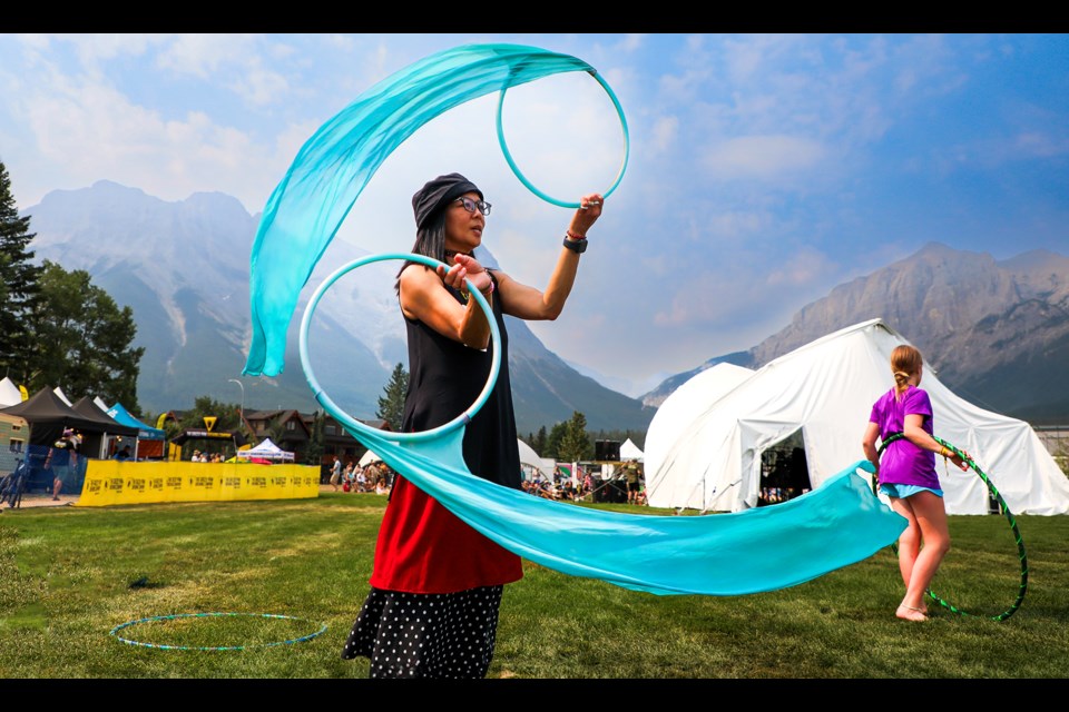 Tessa Mendoza performs a charming dance using two hula hoops at the Canmore Folk Festival in Centennial Park on Saturday (Aug. 3). JUNGMIN HAM RMO PHOTO