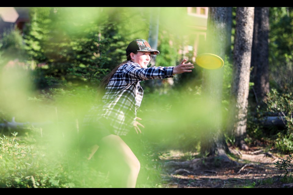 Megan Petty throws a disc at a target at Three Sisters disc golf course in Canmore on Friday (Aug. 10). JUNGMIN HAM RMO PHOTO 