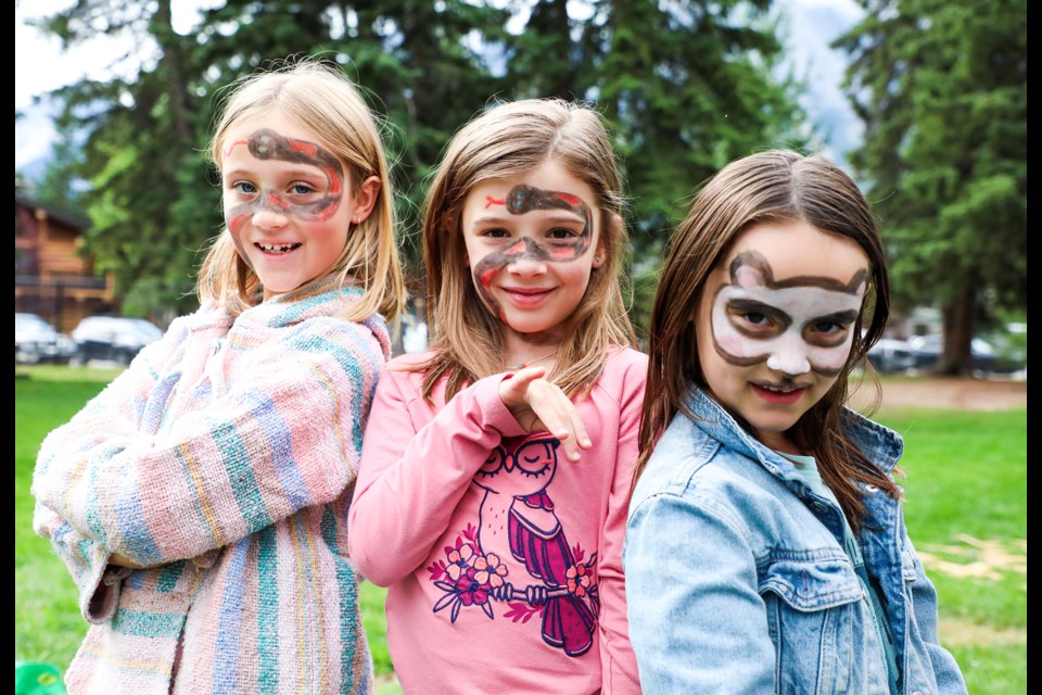 Charlotte Alexander, left, Poppy Rimell, centre, and Etta Alexander pose after face-painting during the Park Day event hosted by the Canmore Public Library at Centennial Park on Saturday (Aug. 17). JUNGMIN HAM RMO PHOTO