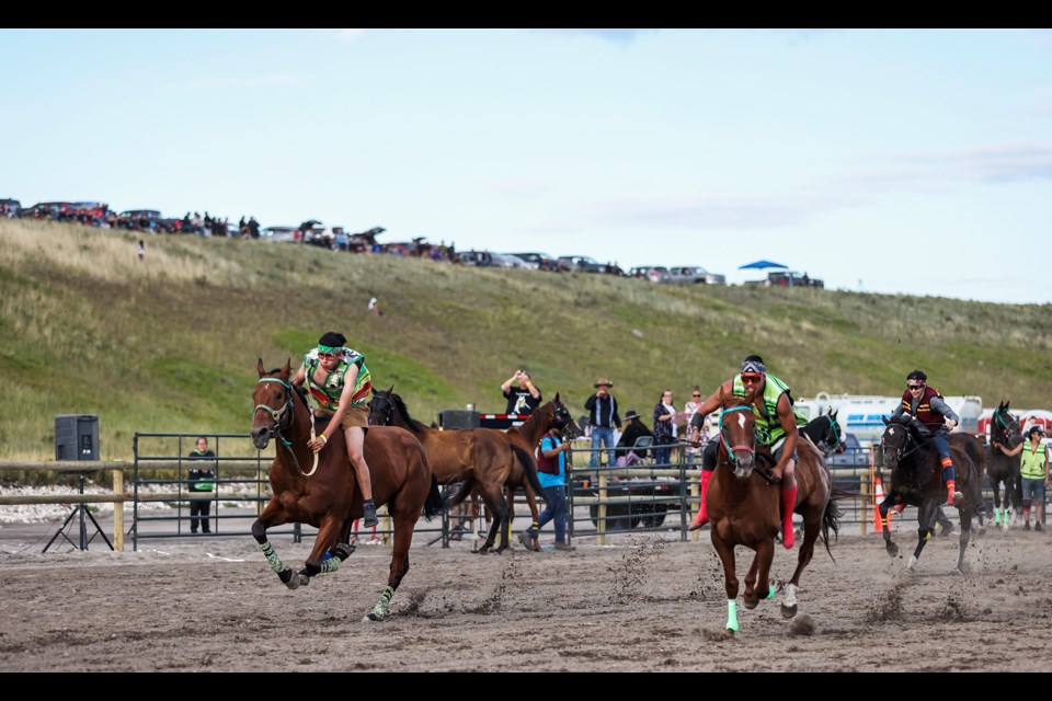 TL Stables, left, TK Farrier, centre and Wild & Cree teams compete at the second annual Mînî Thnî Indian Relay Race at the racetrack near Goodstoney Rodeo Centre in Îyârhe (Stoney) Nakoda First Nation on Saturday (Aug. 17). JUNGMIN HAM RMO PHOTO