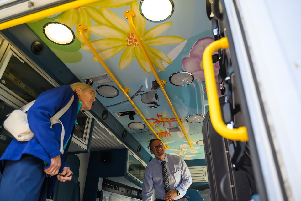 Lynn Heersink, left, and Chris de Vries admire the newly painted roof of an ambulance at the Banff Mineral Springs Hospital on Tuesday (Aug. 20). MATTHEW THOMPSON RMO PHOTO