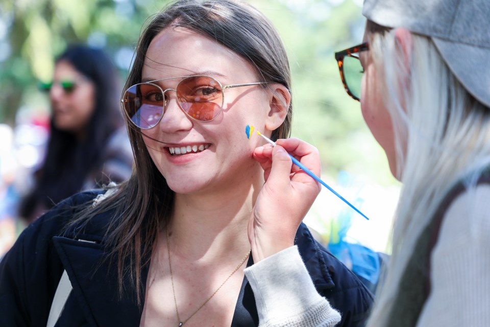 Alisa Rybka gets a Ukrainian flag in the shape of a heart painted on her face during the Ukrainian United Fest at Centennial Park in Canmore on Saturday (Aug. 24). JUNGMIN HAM RMO PHOTO 