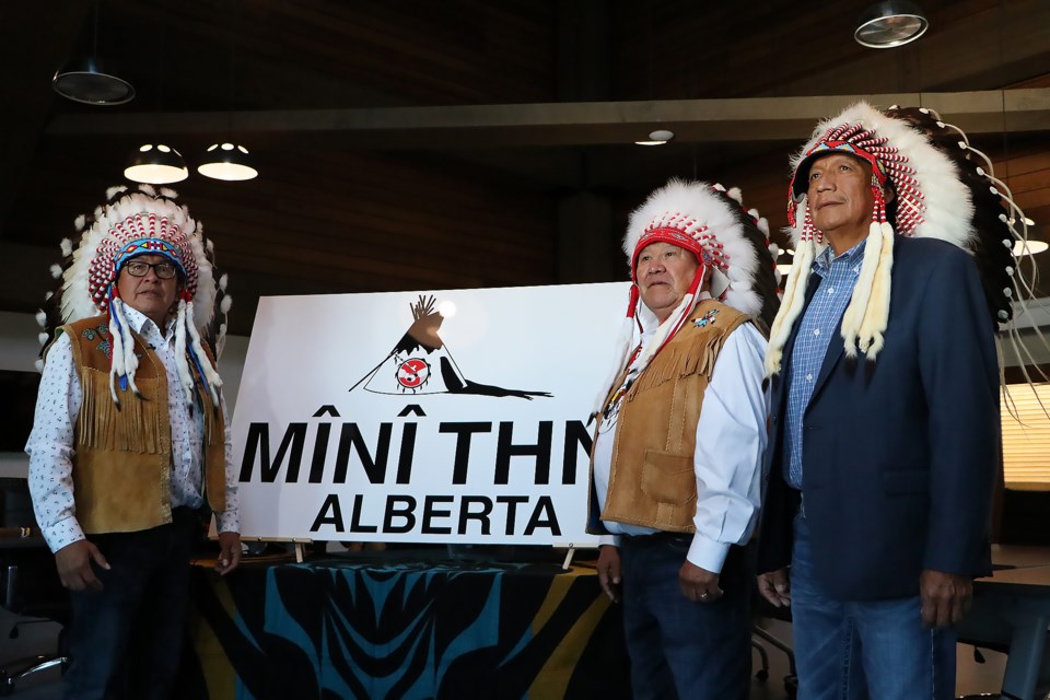 Chiniki First Nation Chief Aaron Young, left, Goodstoney First Nation Chief Clifford Poucette and Bearspaw First Nation Chief Darcy Dixon gather for a photo in front of a Mînî Thnî sign, honouring reclaiming the name Mînî Thnî for the former Morley townsite on Thursday (Aug. 29).

JESSICA LEE RMO PHOTO