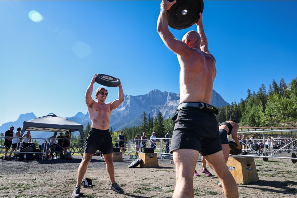 Team Matt's angels' Matt Lavigne, left, and Brian Yakiwchuk complete a devil press during the outdoor CrossFit event Rocky Mountain Crusher at the Canmore Nordic Centre on Saturday (Aug. 31). JUNGMIN HAM RMO PHOTO 