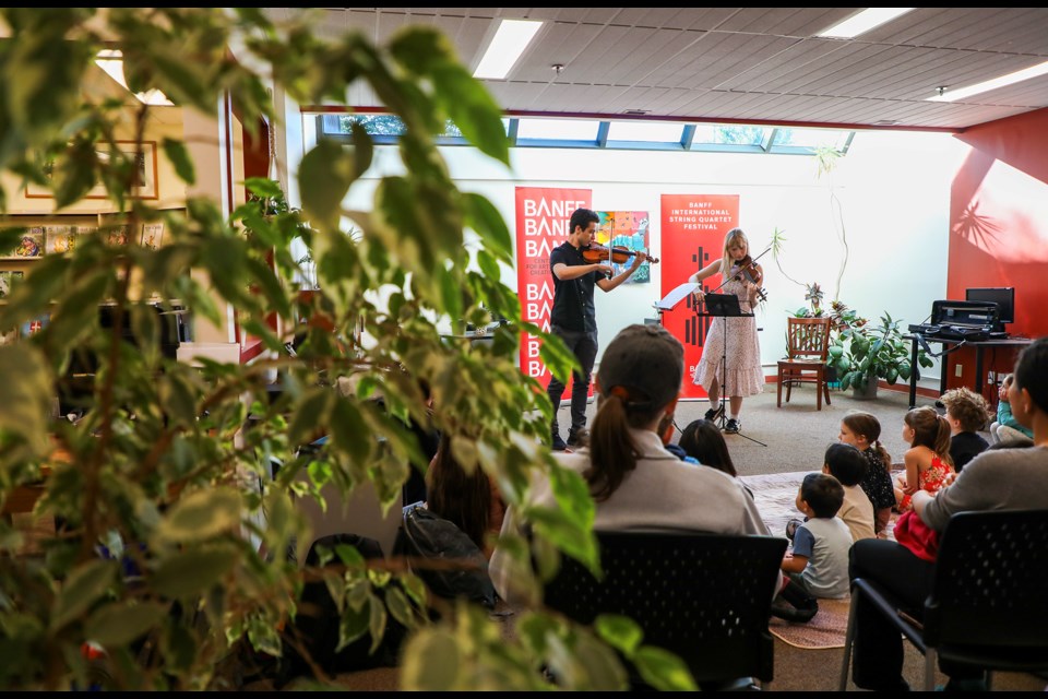 Violinist Evan Pyne and Ehrentraud Moser perform with perfect harmony during the Once Upon An Alphabet Storytime at Banff Public Library on Saturday (Aug. 31). Pyne and Moser visited the Banff Public Library as part of their performance at the Banff International String Quartet Festival (BISQFest). JUNGMIN HAM RMO PHOTO