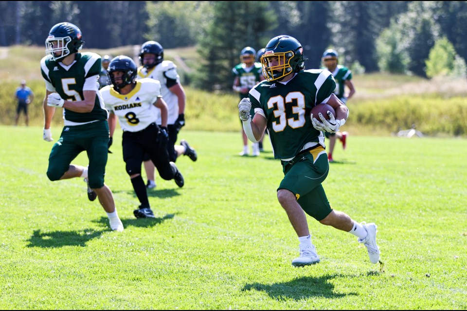 Canmore Wolverines Felix Dansereau rushes to the outside against the Carstairs Kodiaks during the season home opener at Millennium Park in Canmore on Saturday (Sept. 7). JUNGMIN HAM RMO PHOTO