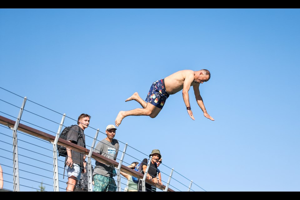 With a mighty leap, Ameen Alyasiri jumps off the Nancy Pauw Bridge into the chilly Bow River in Banff on Saturday (Sept. 7).  JUNGMIN HAM RMO PHOTO