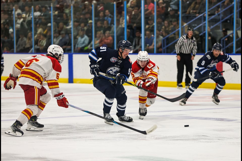 Canmore Eagles forward Zach Coutu uses his speed to beat the Calgary Canucks defencemen during the Eagles home opener against the Calgary Canucks at the Canmore Recreation Centre on Friday (Sept. 13). The Eagles beat the Canucks 4-3 in overtime. JUNGMIN HAM RMO PHOTO