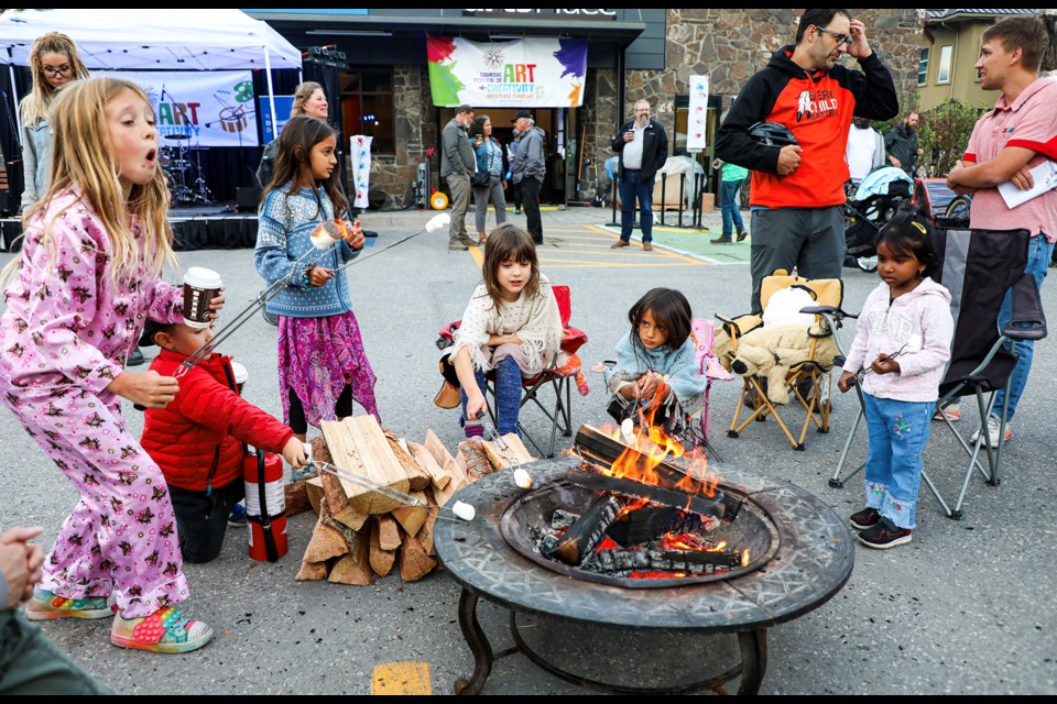 Kids roast marshmallows at an outdoor fire pit during the Outdoor Concert and Community Campfire at the Canmore Festival of Art and Creativity on Friday (Sept. 13). JUNGMIN HAM RMO PHOTO