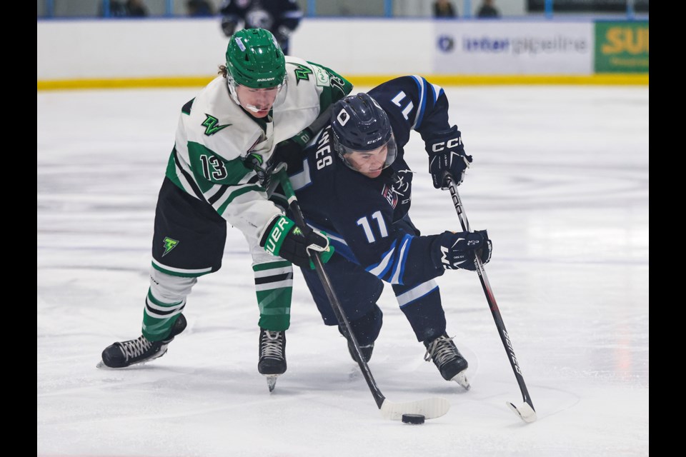 Canmore Eagles forward Owen Jones fights for possession of the puck with the Drayton Valley Thunder Ben Buckley during a game at the Canmore Recreation Centre on Friday (Sept. 20). The Thunder beat the Eagles 5-2. JUNGMIN HAM RMO PHOTO