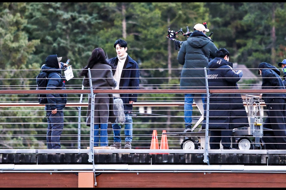 Netflix series 'Can This Love Be Translated?' filming on the Banff Pedestrian Bridge in Banff on Tuesday (Oct. 8). JUNGMIN HAM RMO PHOTO