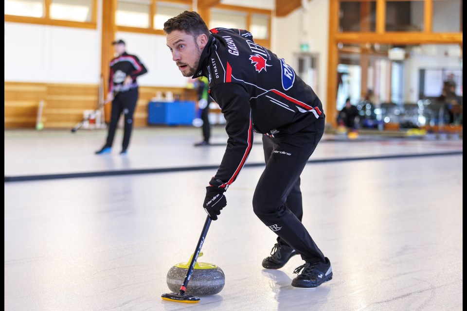 Brett Gallant sweeps his rock roll into the house during the match of the Rocky Mountain Mixed Doubles Classic at the Fenlands Banff Recreation Centre on Thursday (Dec. 5). JUNGMIN HAM RMO PHOTO