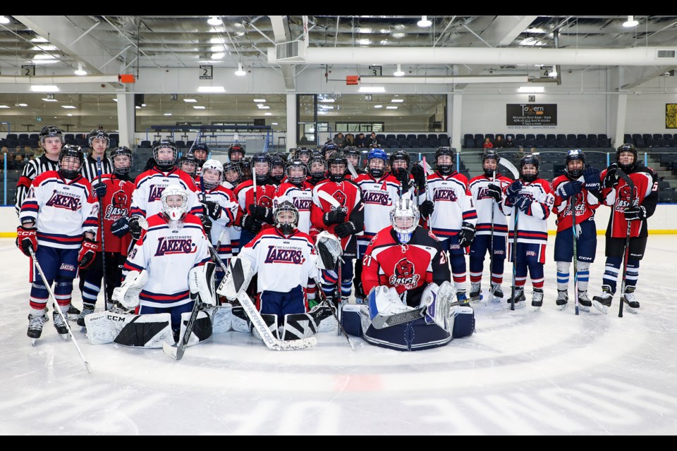 The Canmore Eagles U15 players wearing Jasper U15 Bearcats jerseys, Chestermere Lakers U15 players pose at the Canmore Recreation Centre on Saturday (Jan. 25). JUNGMIN HAM RMO PHOTO