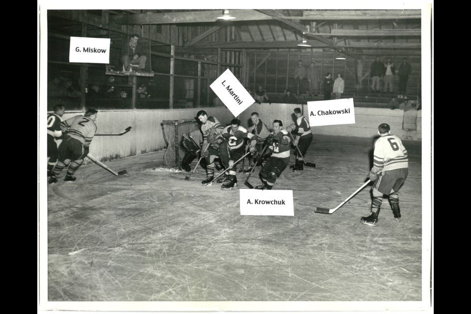 A snapshot of a hockey game being played in the old Canmore arena between 1949-50. Image 2010.031.028 COURTEST OF CANMORE MUSEUM