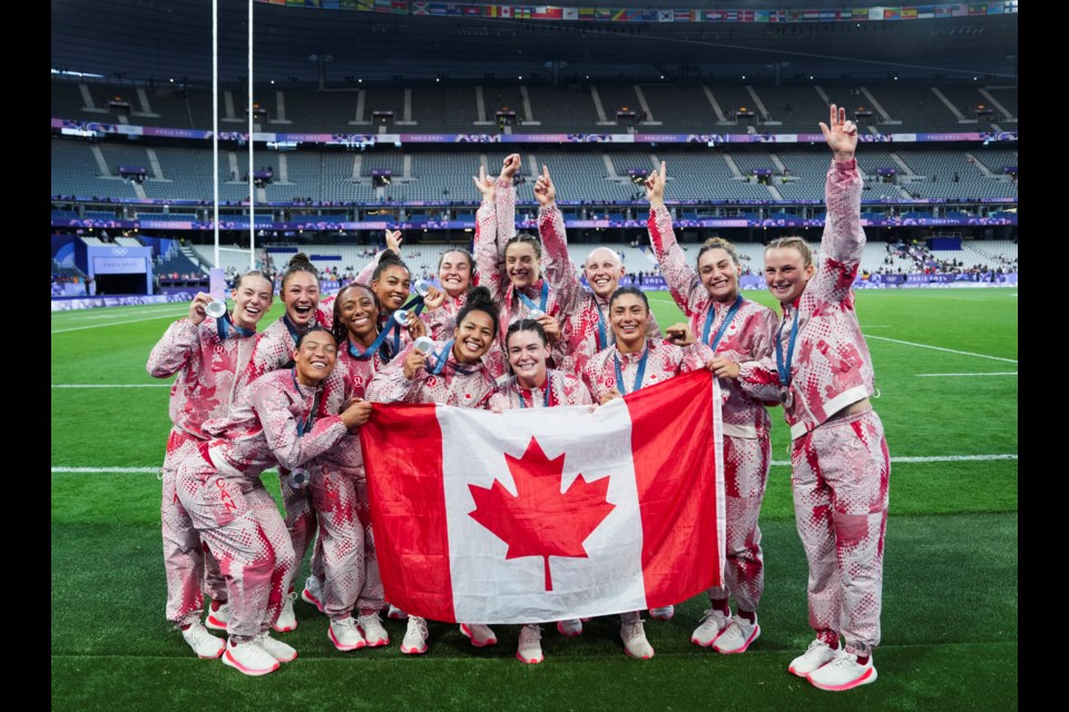 Team Canada's rugby sevens team holds up their silver medals at Paris 2024 on Tuesday (July 30). DARREN CALABRESE CANADIAN OLYMPIC COMMITTEE PHOTO